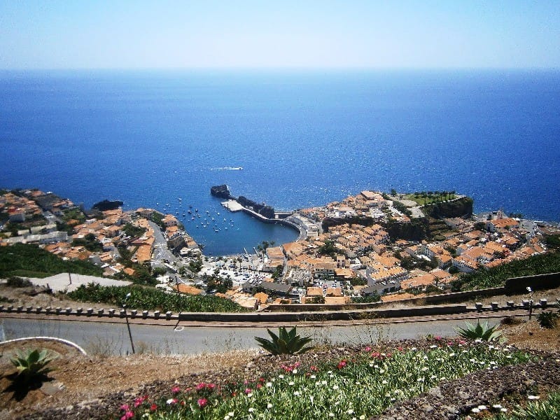 Coastal cliff road above the ocean in Madeira seen from a motorbike